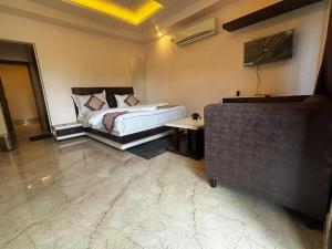 a bedroom with a bed and a table in it at GOLDEN VISTA RESORT - 10 Minute From Mayapur Temple in Krishnanagar