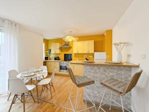 a kitchen and dining room with a table and chairs at L'Ecrin - Spacieux & Garage Privé - Calme à 5minutes de Rennes in Pacé +18 photos