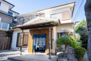 a house with a blue door in front of it at 空 Kuu in Odawara