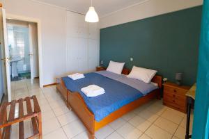a bedroom with a bed with two towels on it at Amadolia in Loutra Edipsou