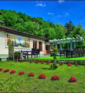 a house with a patio and a yard with flowers at Cornu Complex Mem in Campina +7 photos