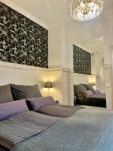 a bedroom with two beds and a chandelier at der Elbe so nah 2 in Dömitz