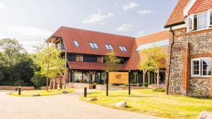 a large brick building with a sign in front of it at Wallace Hill Cottage - Garsington Studios - Pass the Keys in Stokenchurch