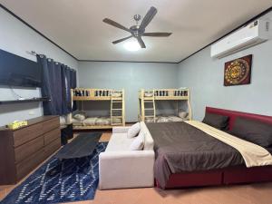 a bedroom with a bed and a ceiling fan at Saensuk stay in Ban Wang Thong +6 photos