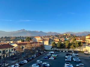 a city with cars parked in a parking lot at L'Appartamentino Montagna in Biella