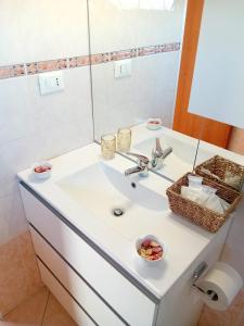 a bathroom with a sink and a mirror at La Dimora di Deborah Terrazza Panoramica, Centro & Stazione a 4 min, Relax e Comfort in Montecatini Terme +15 photos