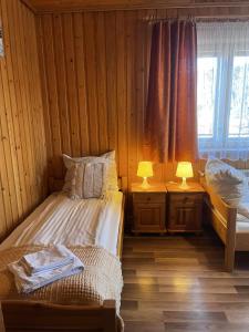 Ένα ή περισσότερα κρεβάτια σε δωμάτιο στο DW Łomnica