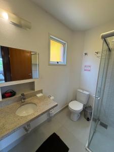 a bathroom with a sink and a toilet at Vila dos Cristais - Apartamentos de Temporada in Alto Paraíso de Goiás +68 photos