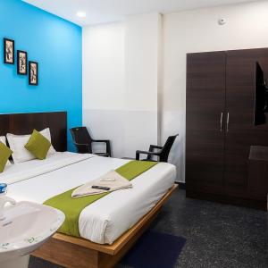 a bedroom with a bed and a sink and a bathroom at Hotel Heaven Stay in Shankerpalli