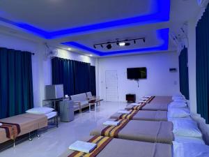 a hospital room with several beds and a tv at Chiang Rai Khuakrae Resort in Chiang Rai