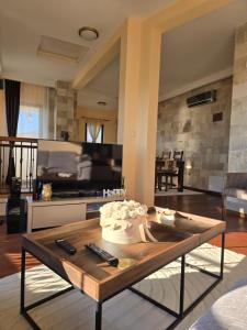 a living room with a table with a cake on it at Vista Blue Villa in Budva +35 photos