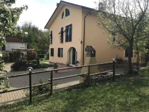 a house with a fence in front of it at Il cotogno in Carrosio