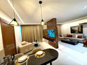 a living room with a couch and a tv at King Suites Hotel in Beirut