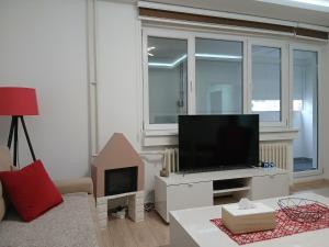 a living room with a flat screen tv on a table at Novi Priboj in Čitluk