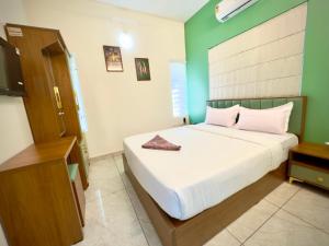 Postel nebo postele na pokoji v ubytování Tokyoz Inn Calicut