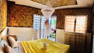 a bedroom with a bed with a teddy bear in a net at Diapila baybayon Sunset View in El Nido +58 photos