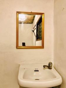 a bathroom with a sink and a mirror at Diapila baybayon Sunset View in El Nido