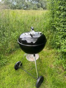 a black barbecue grill sitting in the grass at Morpeth, Northumberland home in Morpeth