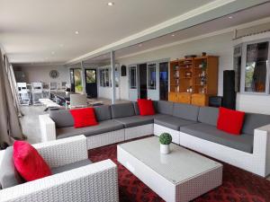 a living room with a couch and red pillows at The Glen Getaway in Lake Brenton