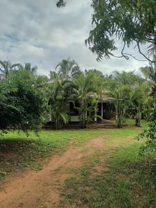 a house with palm trees in front of it at Whispering Wind Yala in Kirinda