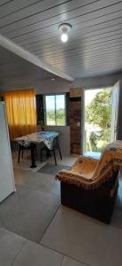 a room with a bed and a table in it at Chalé canto do bugiu in Rio do Sul +11 photos