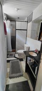 a bathroom with a toilet and a sink at Chalé canto do bugiu in Rio do Sul
