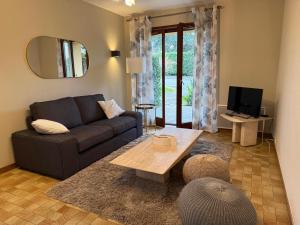 a living room with a couch and a table at La ferme de Marin in Marin