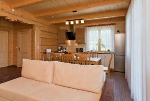 a living room with a couch and a kitchen at Gorczański Domek - Koninki in Poręba Wielka