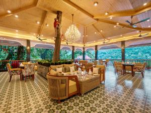 a restaurant with tables and chairs and a chandelier at Mayfair Spa Resort & Casino in Gangtok