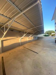 an empty parking lot with awning in a building at Nan Minimal ที่พักน่านมินิมอล in Ban Na Tho