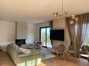 a living room with a couch and a tv at Domaine Santa Margherita in Castellare-di-Casinca