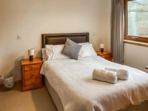 a bedroom with a large white bed with two night stands at Mirodon in Brora