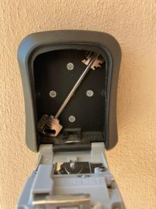 a clock is attached to the side of a wall at Mama House in Naples