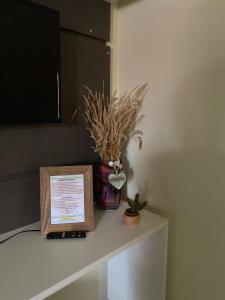 un tavolo con un cartello e una pianta sopra di Apzinho do Centro a Nova Petrópolis