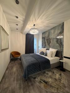 a bedroom with a large bed and a rug at Koralas in Klaipėda