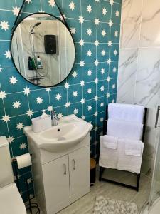a bathroom with a sink and a mirror at St Columb's Cottage in Derry Londonderry