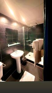 a bathroom with a sink and a toilet and a shower at Hôtel Beauséjour in Marseille