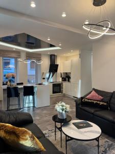 a living room with a couch and a table at Koralas in Klaipėda