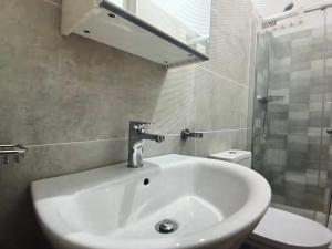 a bathroom with a sink and a shower and a toilet at The Blue Haven in Sal Rei +8 photos