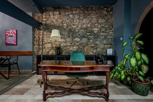 an office with a wooden desk and a green chair at Giselle Buda Castle in Budapest +41 photos
