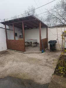 a pavilion with a table and a picnic table at Casa Razu G2 in Craiova