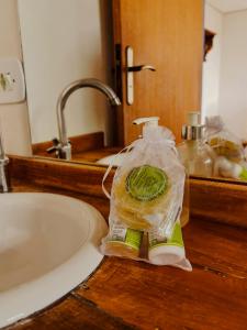 a bottle of soap sitting on a counter next to a sink at Pousada Travessias in Tiradentes