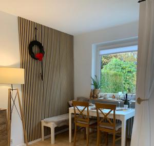 a dining room with a table and chairs and a window at Schwarzwaldliebe in Schönwald
