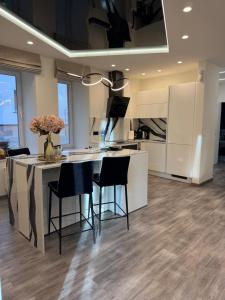 a kitchen with a table with chairs and a counter top at Koralas in Klaipėda