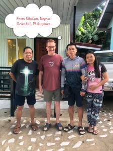 a group of people standing in front of a church at VAL Homestay in Siquijor +6 photos