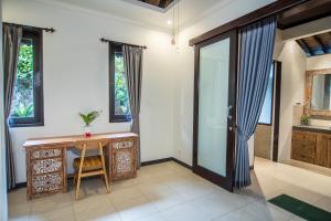 a bathroom with a wooden desk and a sink at Wardana Ubud Villa I in Ubud +23 photos