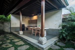 an outdoor kitchen with a table in a house at Wardana Ubud Villa I in Ubud