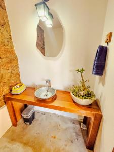 a bathroom with a sink on a wooden table at Pousada Travessias in Tiradentes +123 photos