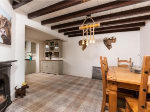 un soggiorno con tavolo in legno e camino di Silver Cottage a Scruton