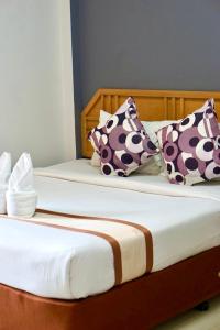 Giường trong phòng chung tại PK Garden Hotel